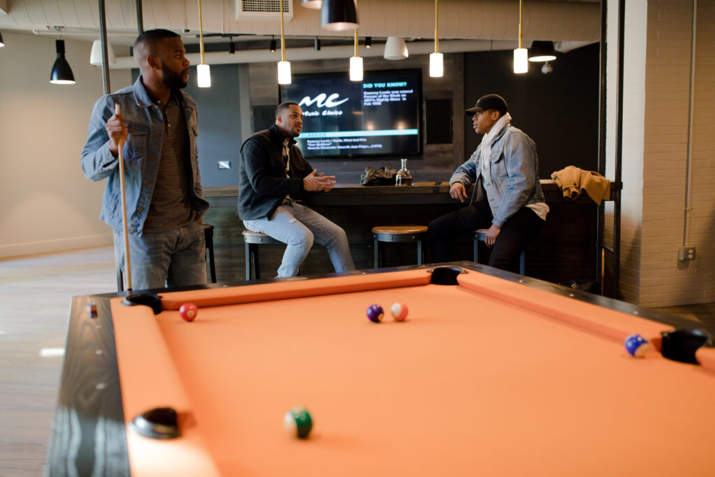 Friends playing a game of billiards