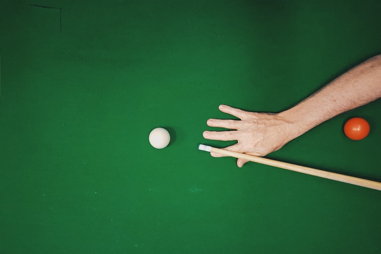 Close up of a person about to shoot a pool ball