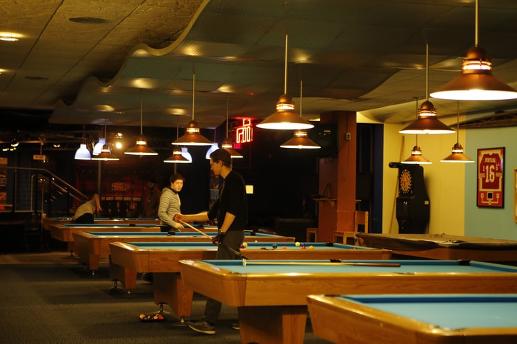 People playing pool in a game center