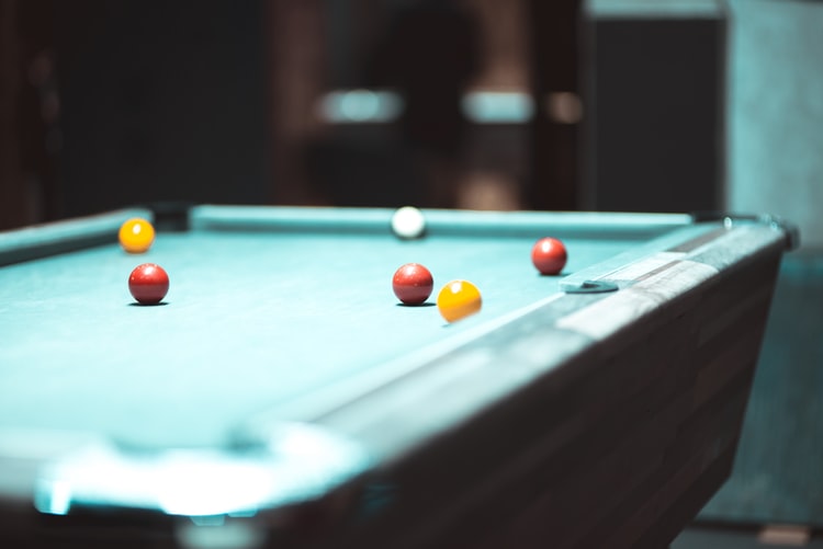 Close up of a pool table with balls