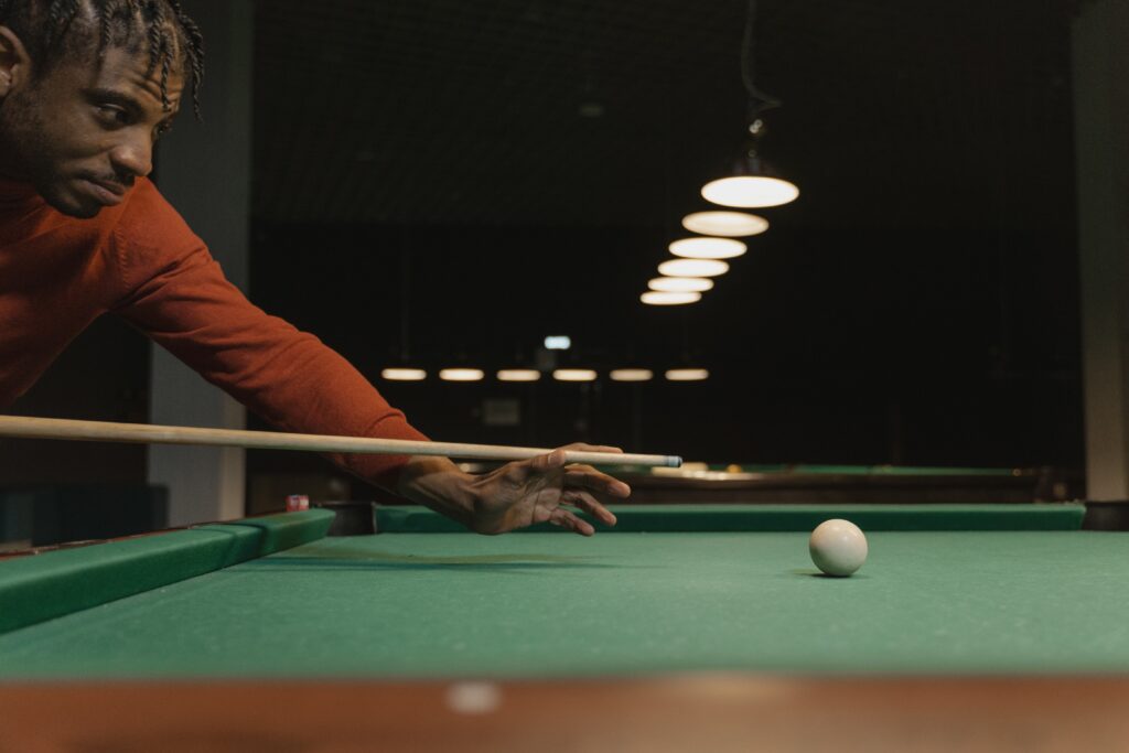 Man using the best low deflection shaft while playing pool