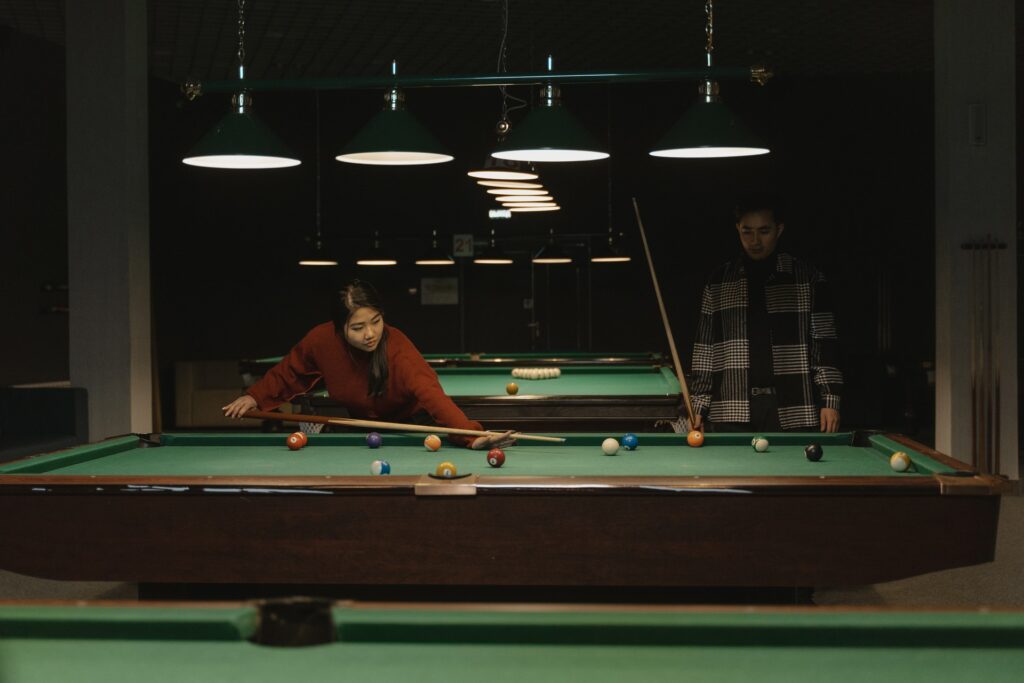 Two people playing pool