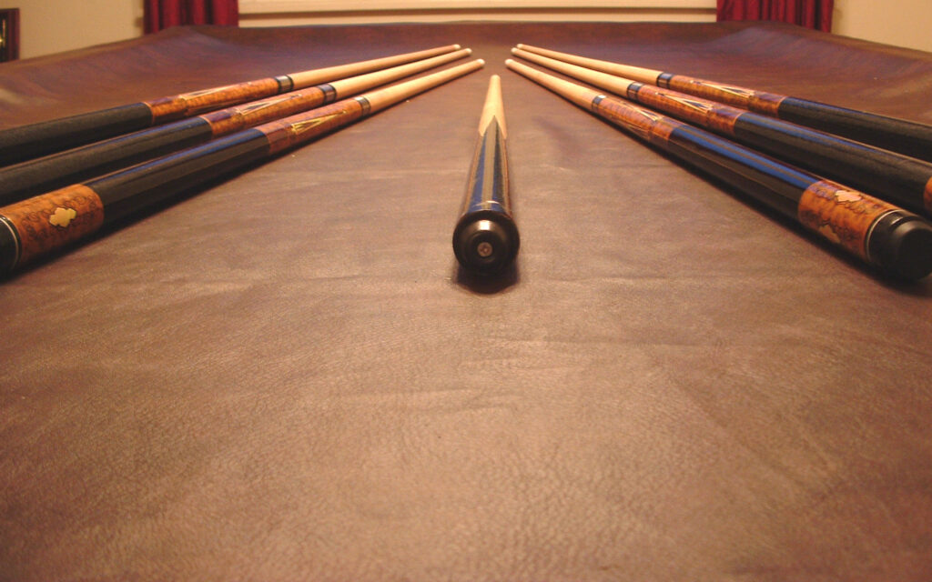 Various pool cue in need of straightening