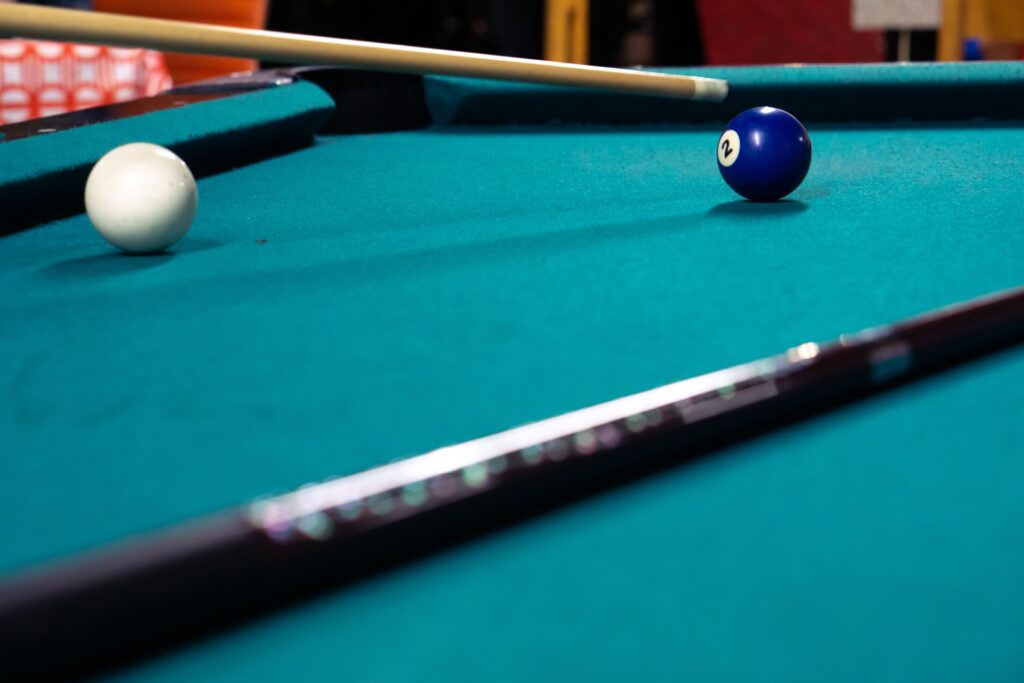 Two billiard balls on a green pool table