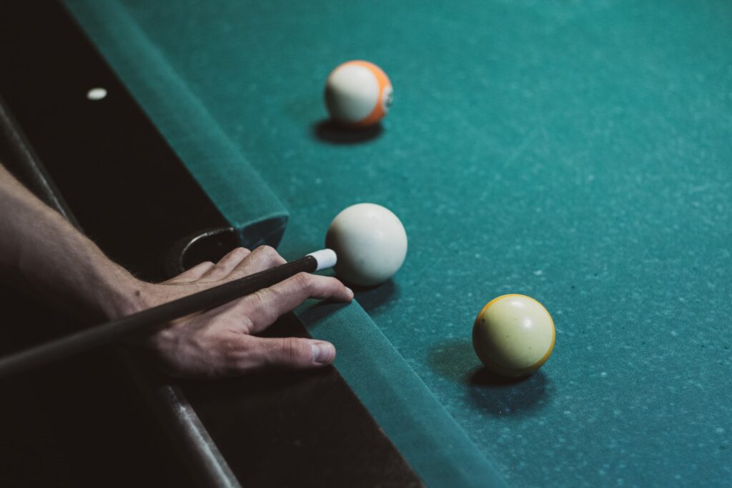 Hand aiming the cue ball