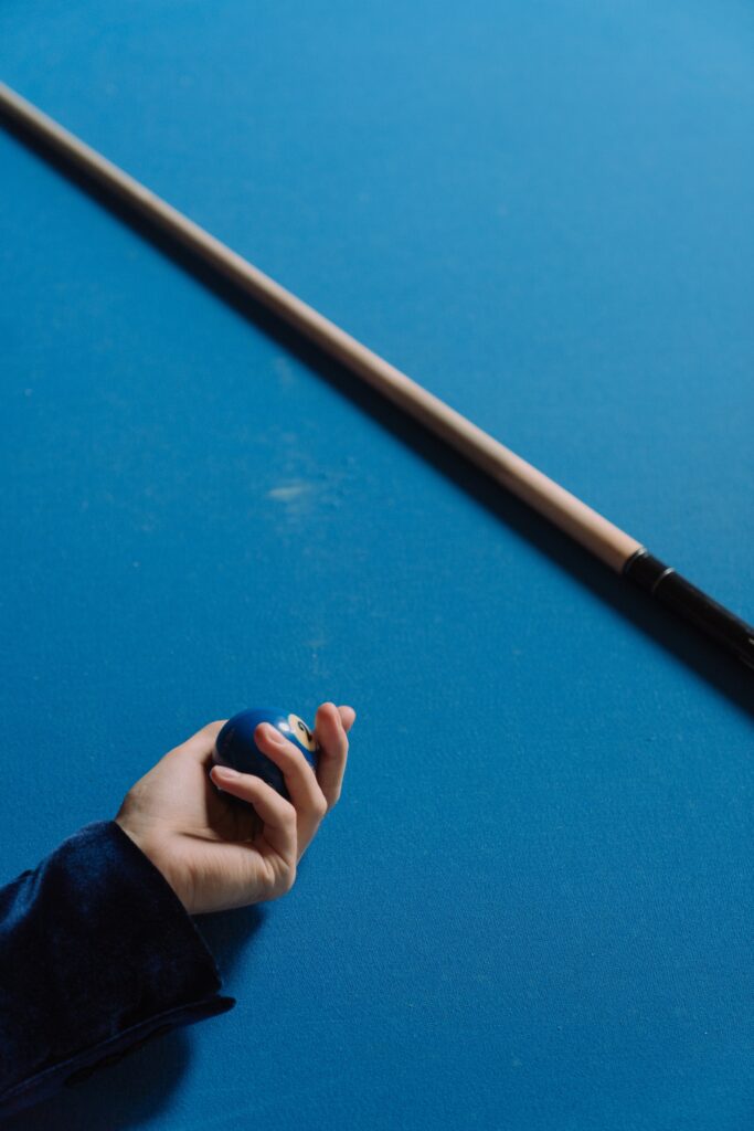 Person holding a cue ball