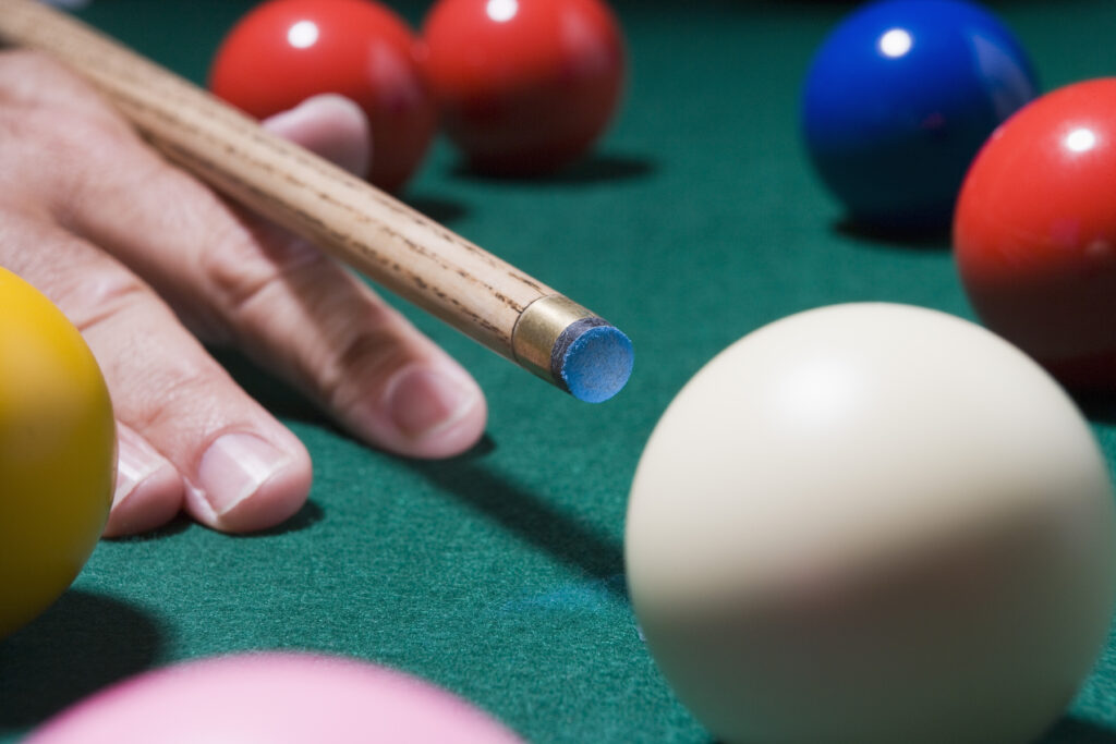 Person using a pool cue for intermediate player