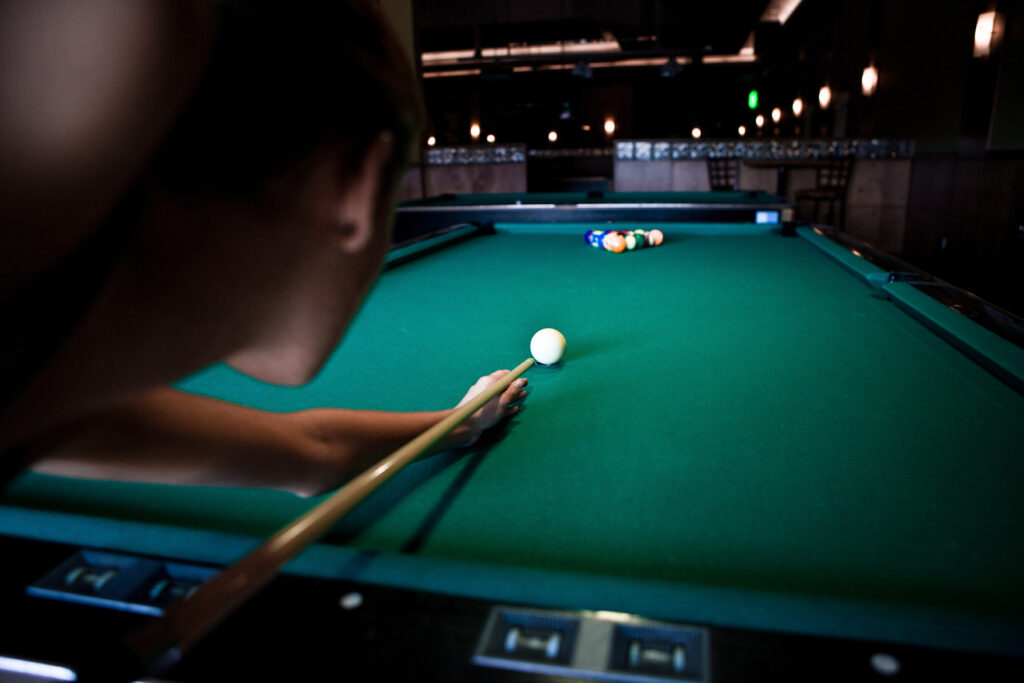 Person playing a game of pool