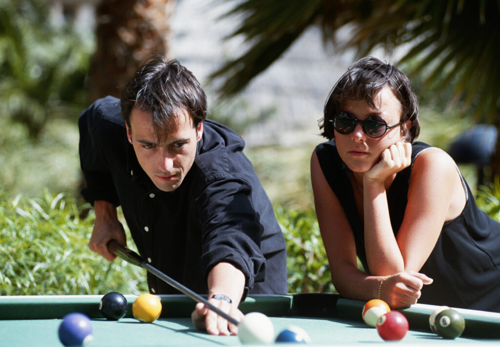 Couple playing on an outdoor pool table