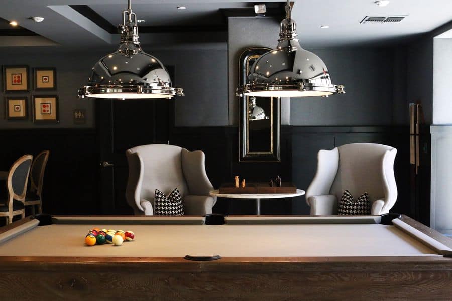 Billiards table with cue balls on top