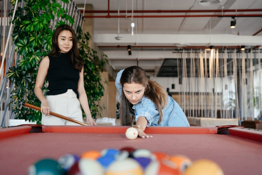 Two people playing pool