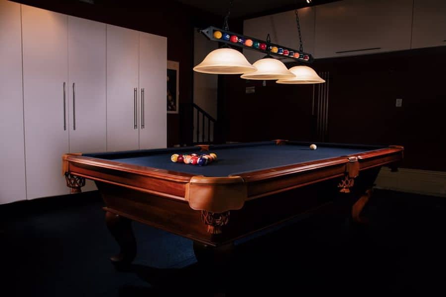 Pool table set with low hanging ceiling lights