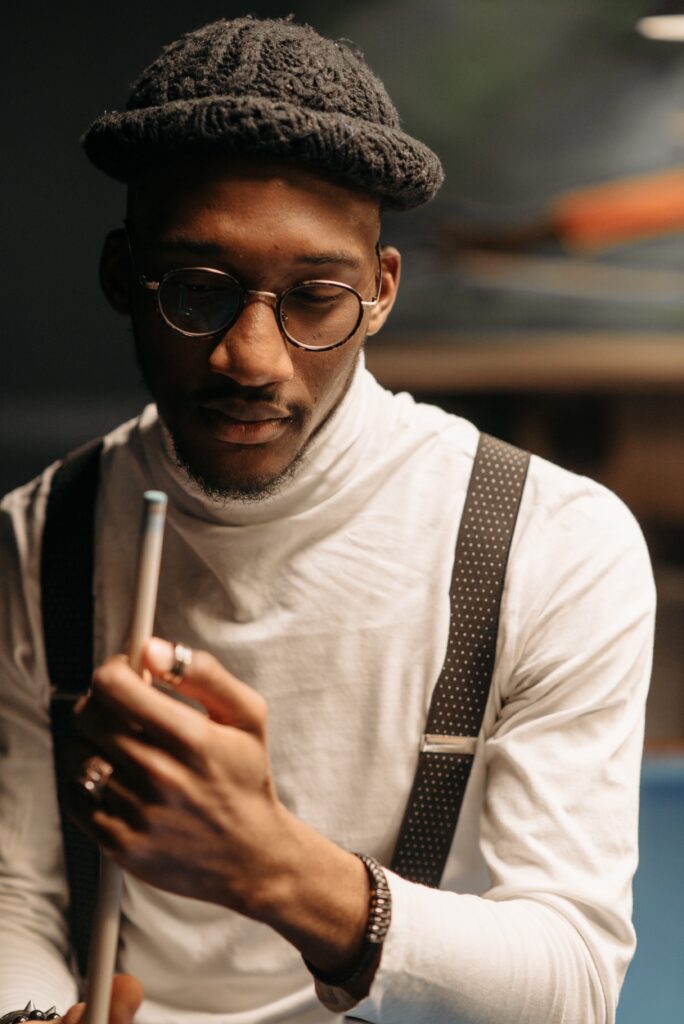 Man holding a pool cue stick