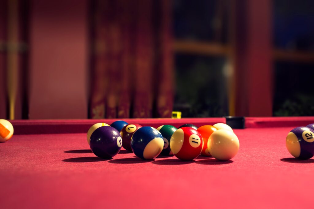 Playing pool with a red table felt cloth