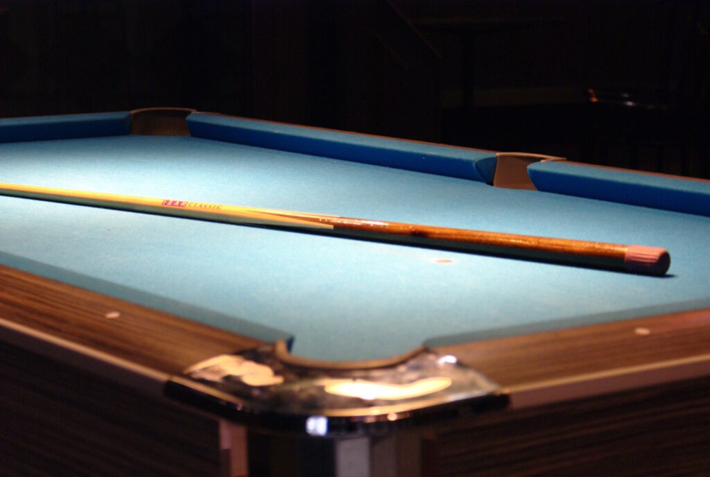 A cue stick on a billiard table