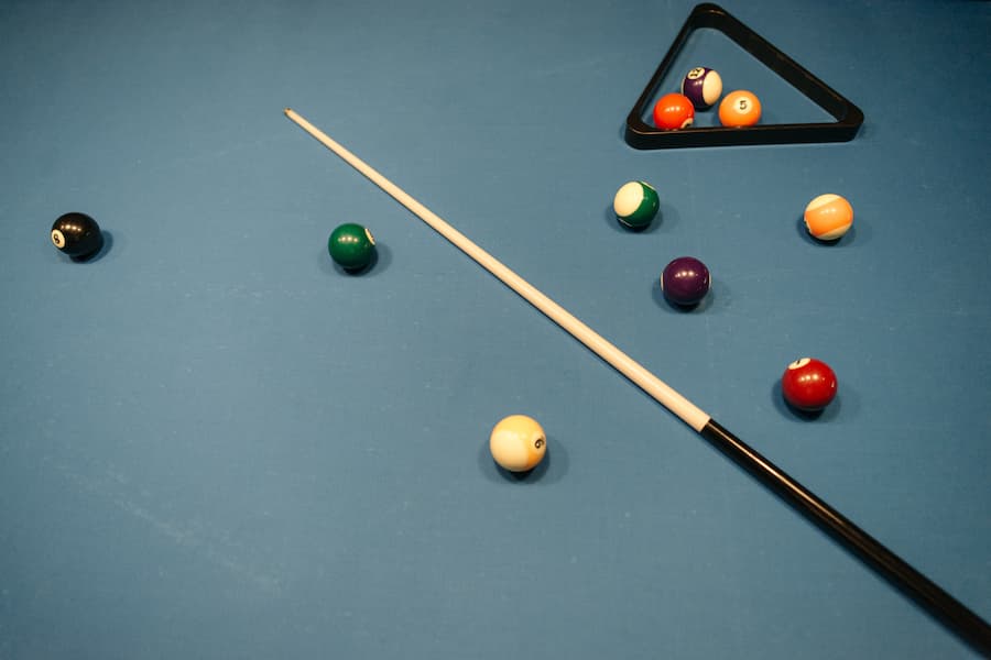 Pool cue with billiard balls