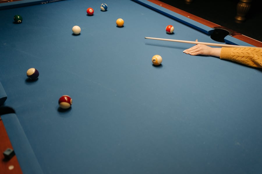 A woman playing pool