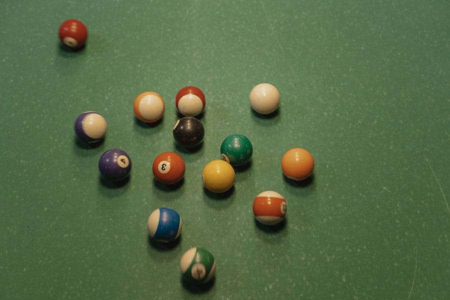 An image of vintage pool balls in green felt